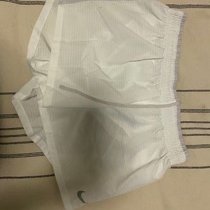 White Nike running shorts